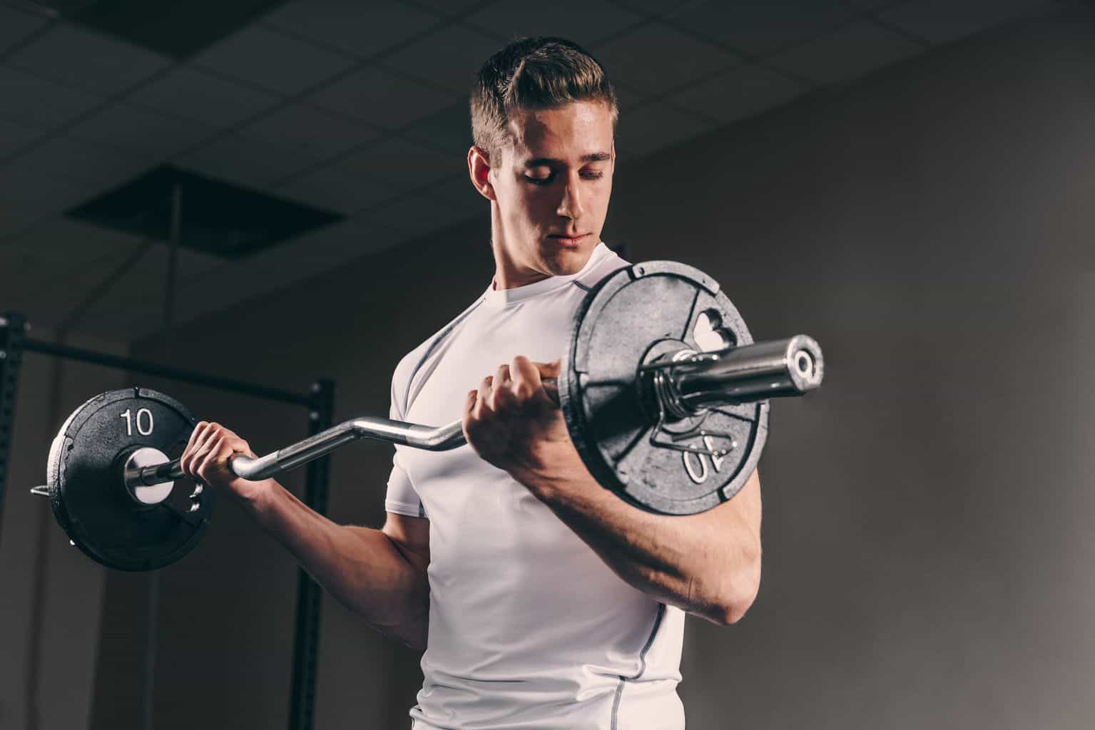 best-home-gym-003 man lifting barbell in best home gym