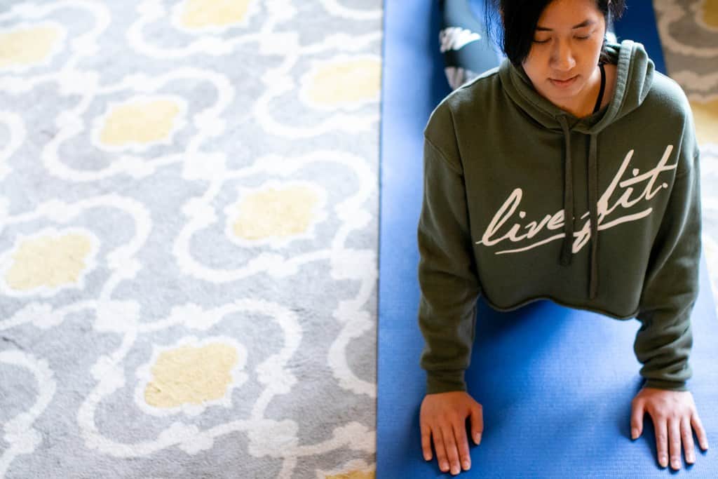 Woman doing yoga exercises in her home gym