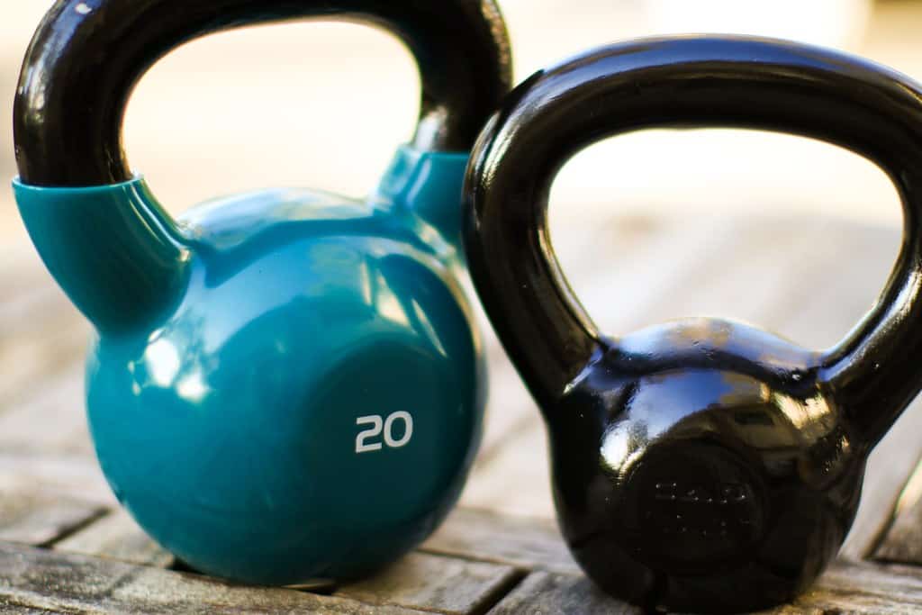 best_kettlebell_068 Several kettlebells sit on a table, one 5 lb kettlebell and another 20 lb kettlebell