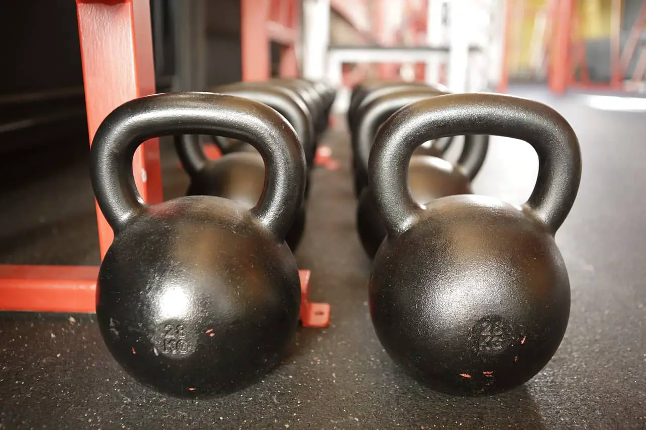 Two rows of kettlebells in varying sizes