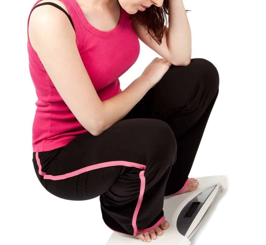 Woman weighing herself