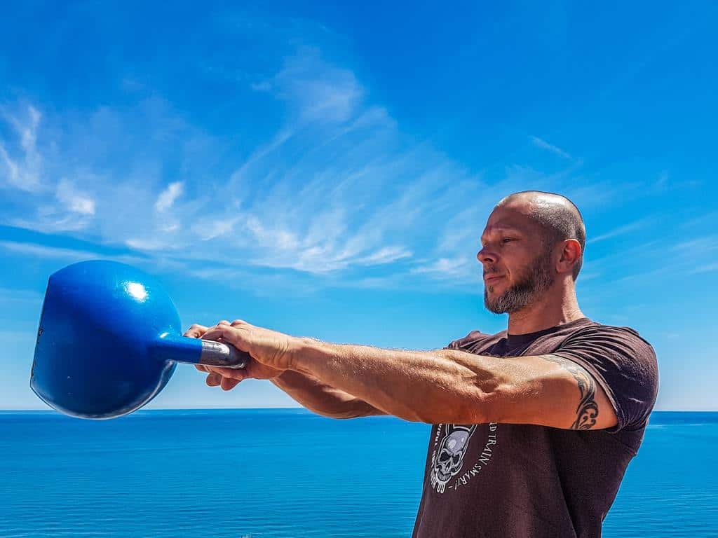 man carrying kettlebell gloves