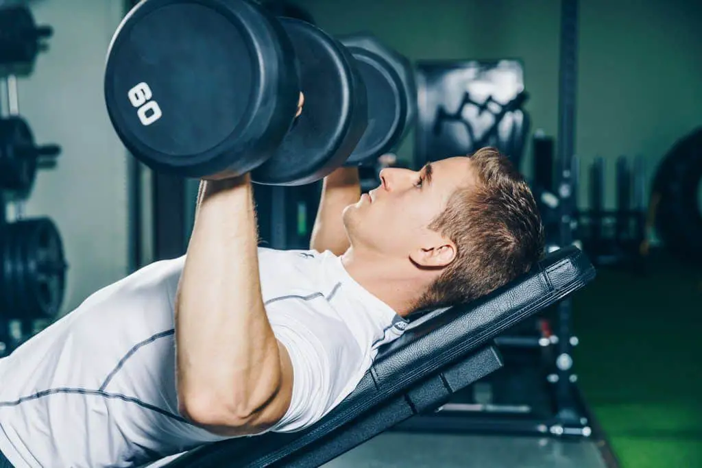 man doing chest exercises at home gym