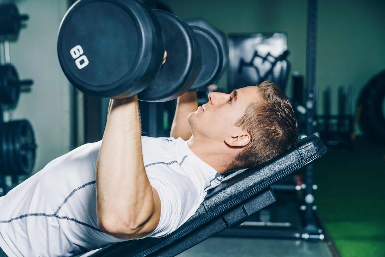 Man doing chest exercises at home gym