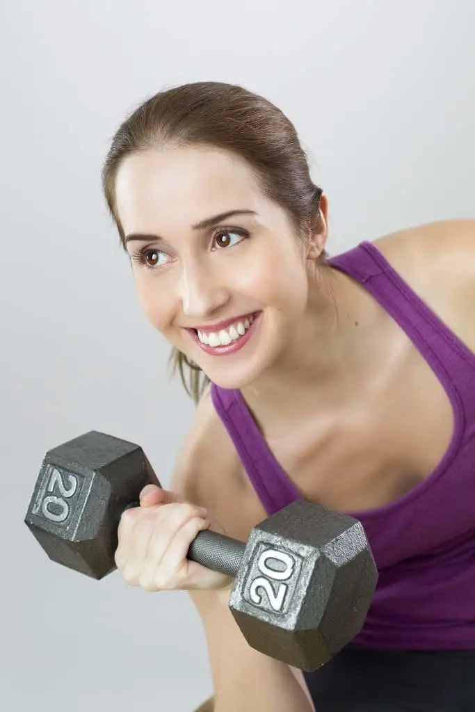 best-home-gym-workout-1 A woman works out at home with a dumbbell