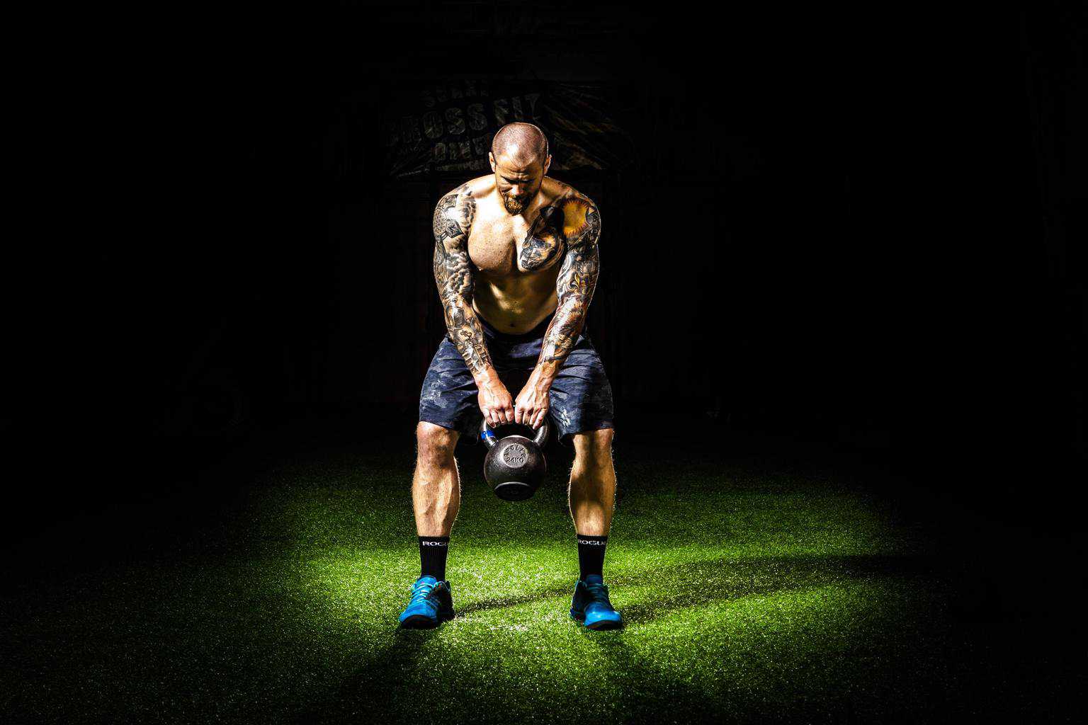 Man carries a large kettlebell