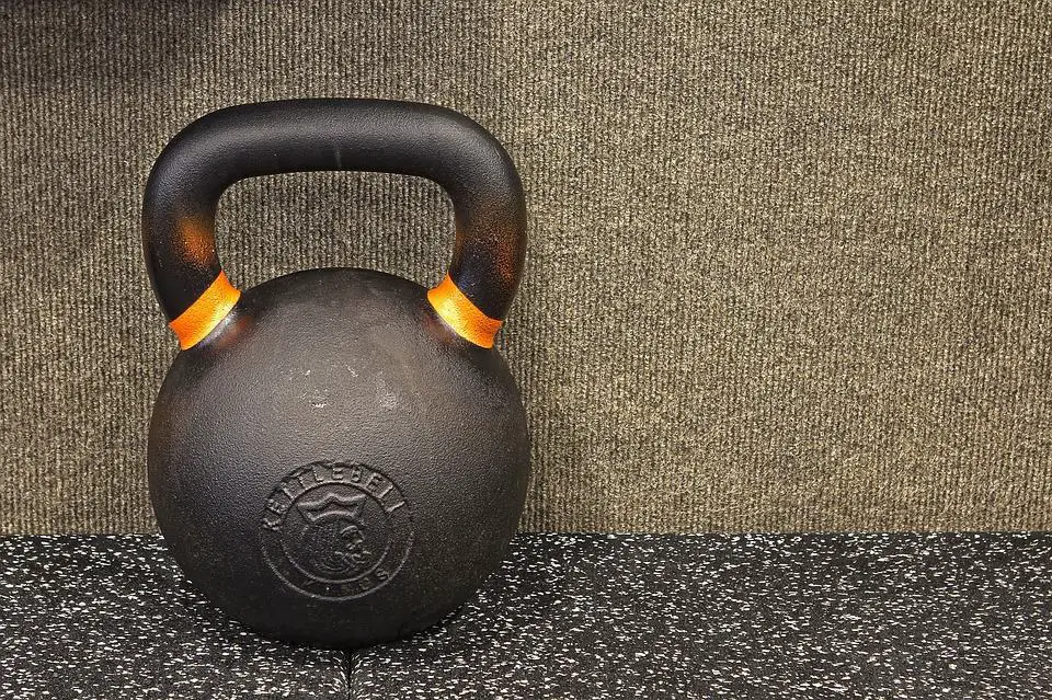 do-kettlebell-swings-work-abs-003 A black iron kettlebell with yellow details
