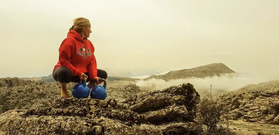 Woman holding two kettlebells