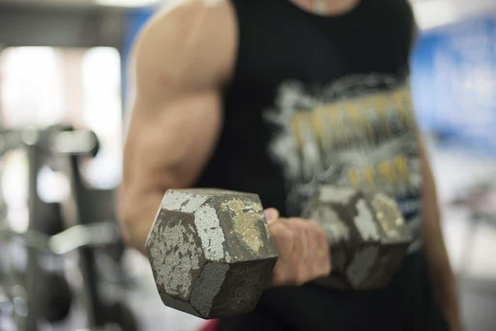 A man lifting a dumbbell with his one hand