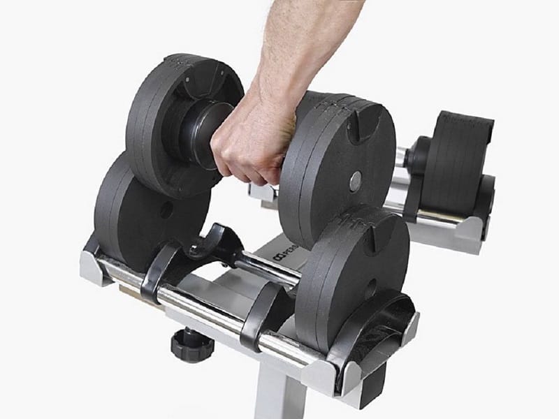 Hand lifting an adjustable dumbbell