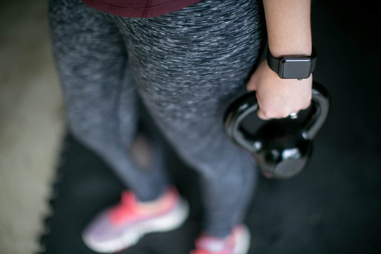 Person wearing a fitness tracker for kettlebell workout