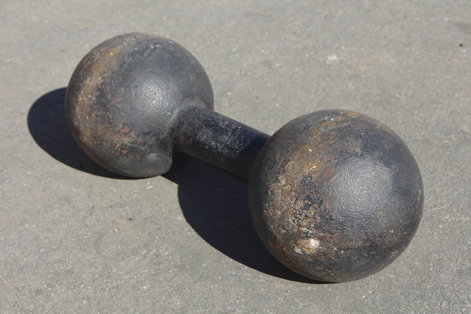 A rusty dumbbell on the ground