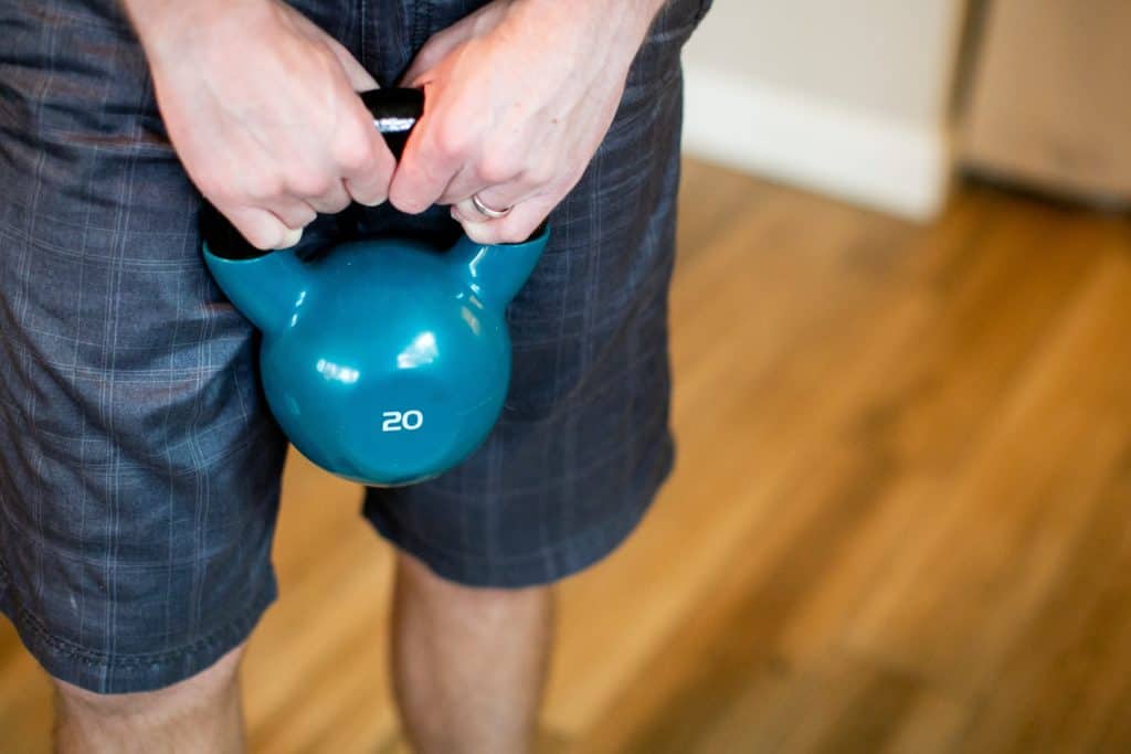 Person holding a kettlebell with both hands