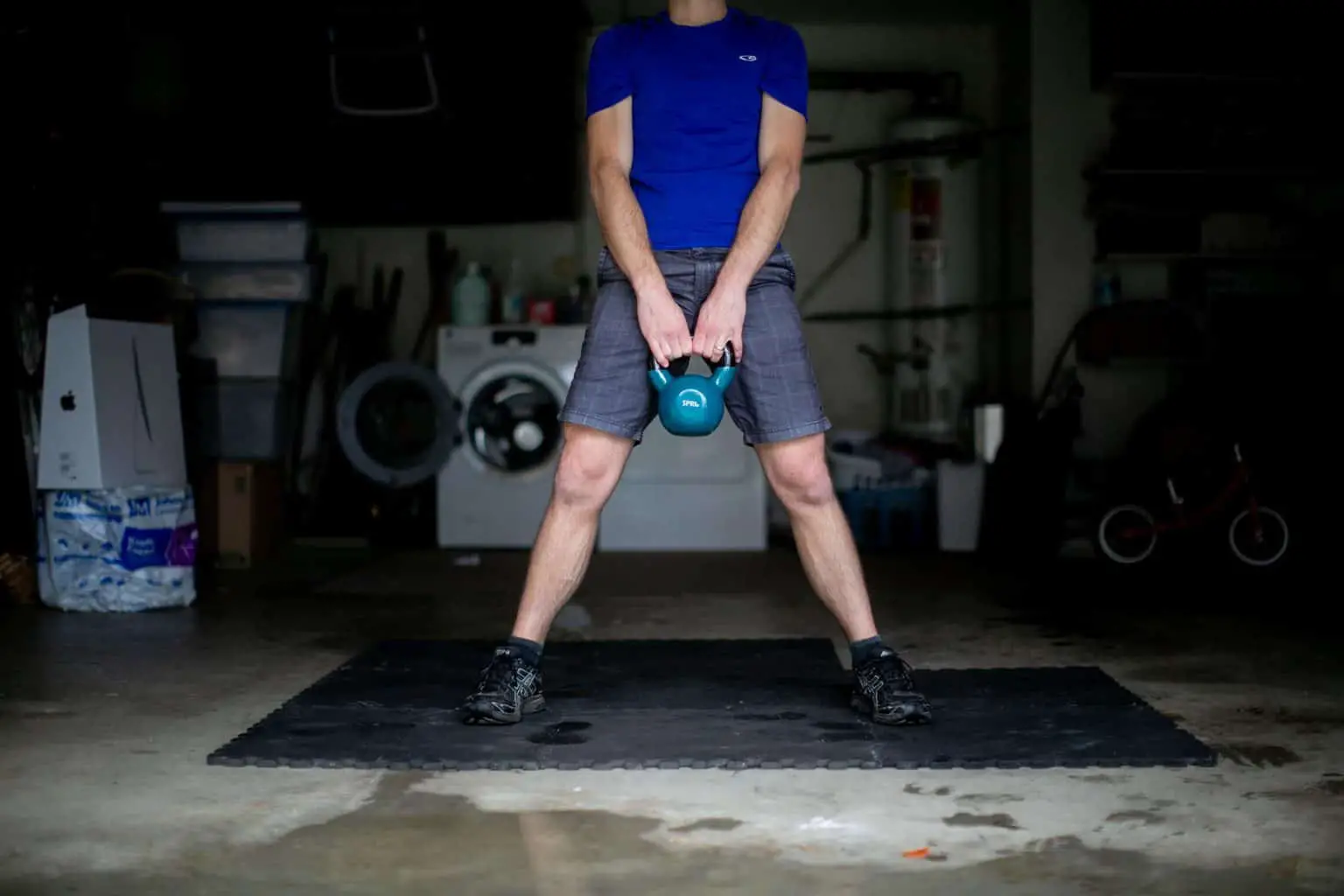 Man holding a kettlebell with both hands