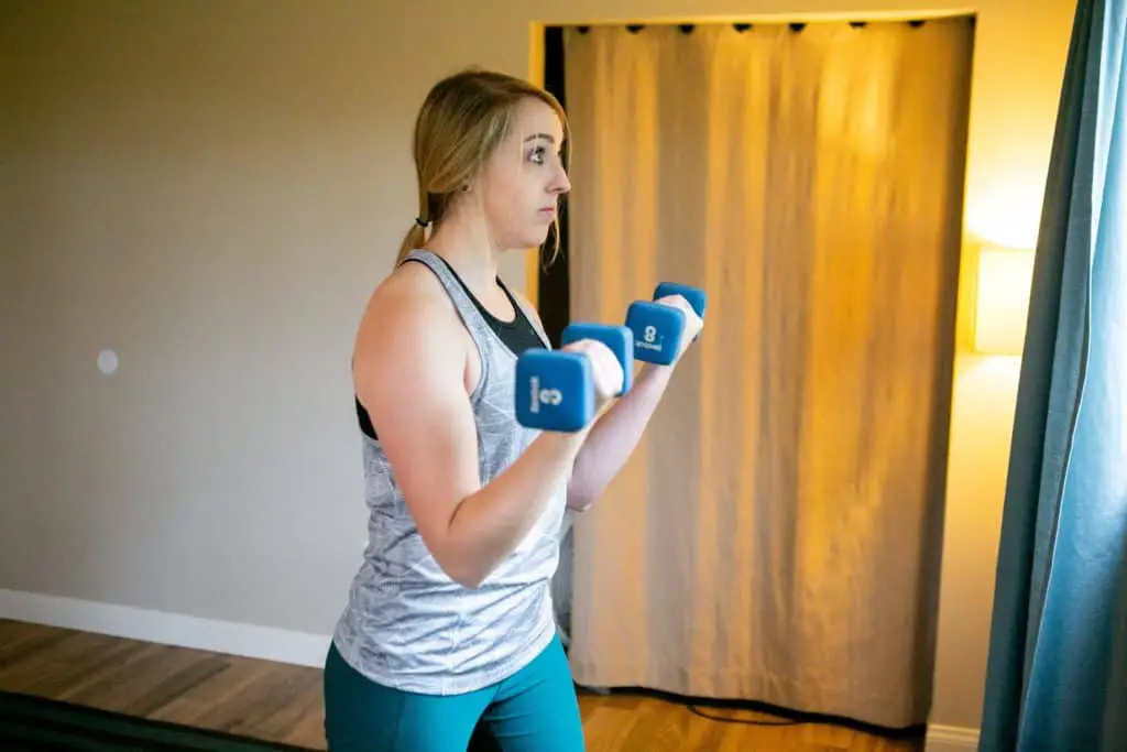 Woman lifting dumbbells with each hand