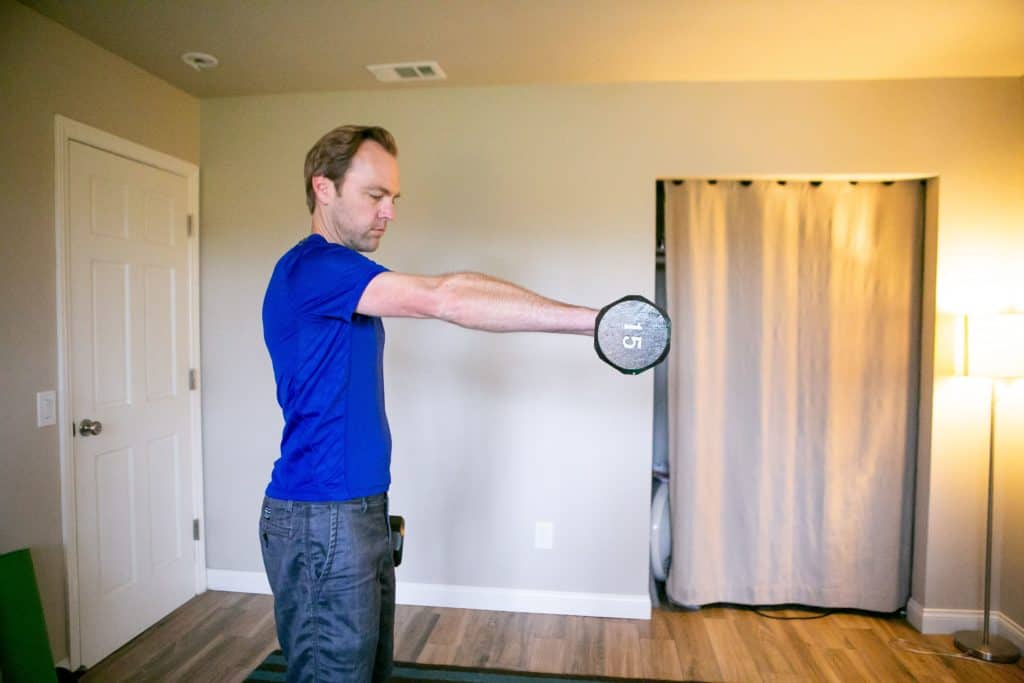 Man lifting a dumbbell while the other hand is holding another one on his side