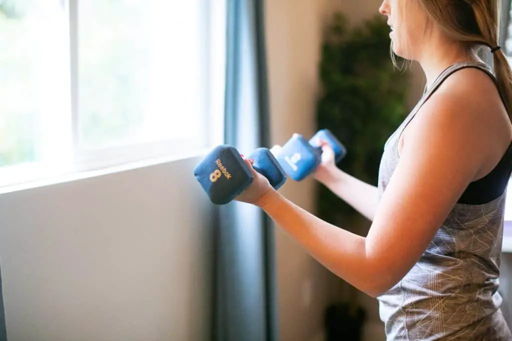 Woman lifting a pair of dumbbells with each hand