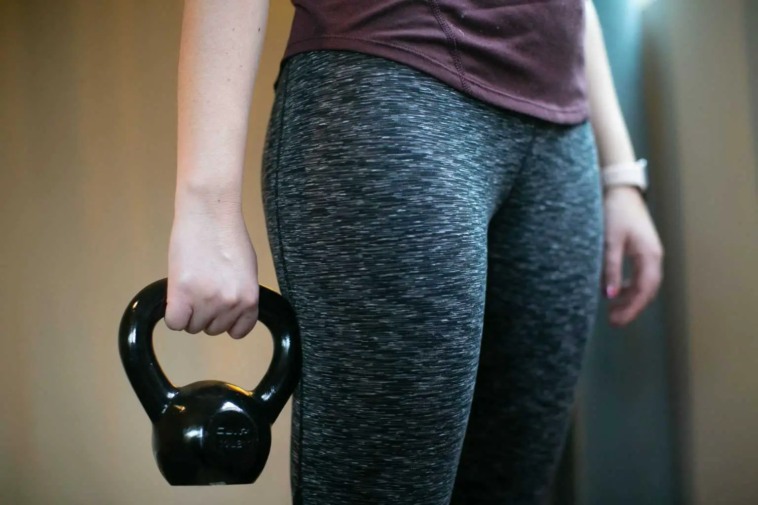 Woman holding a kettlebell in one hand
