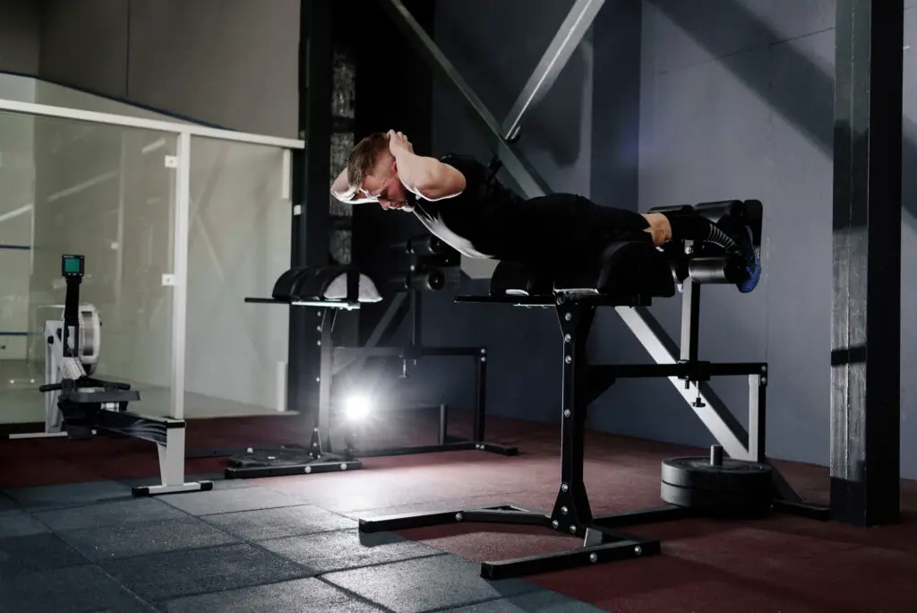 Man using a roman chair for his back muscle exercise