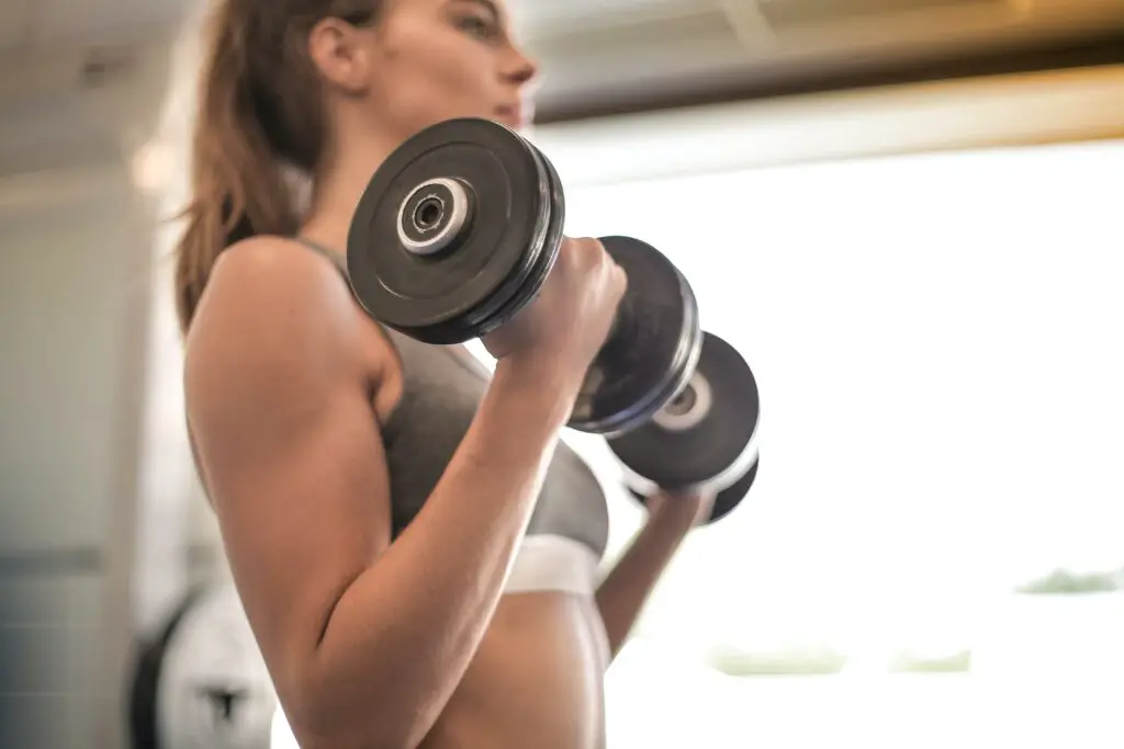 Woman holding a set of dumbbells with both hands