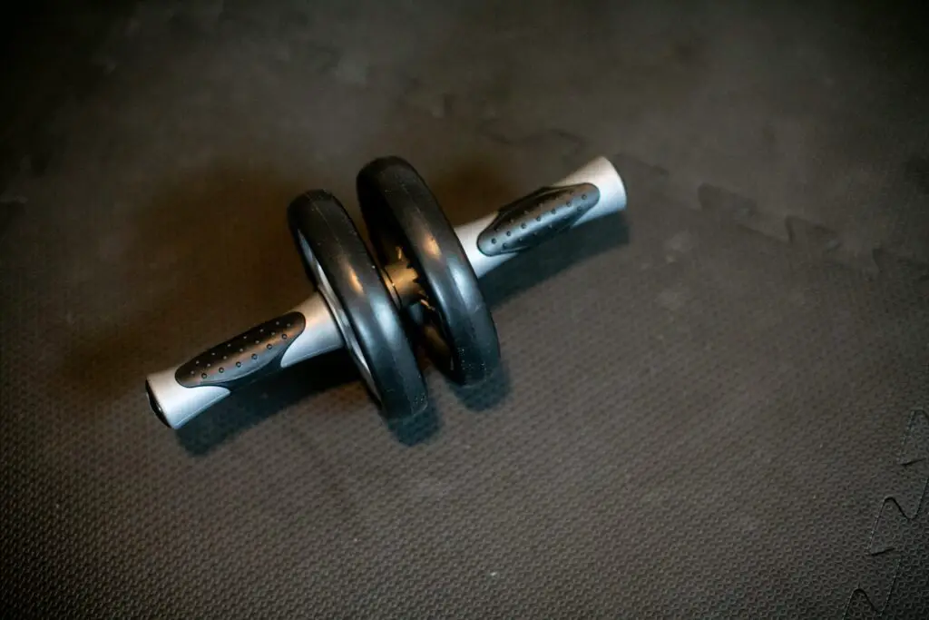 An ab roller placed on the gym floor