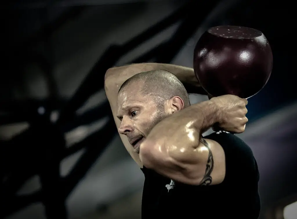 Man performing a kettlebell swings routine