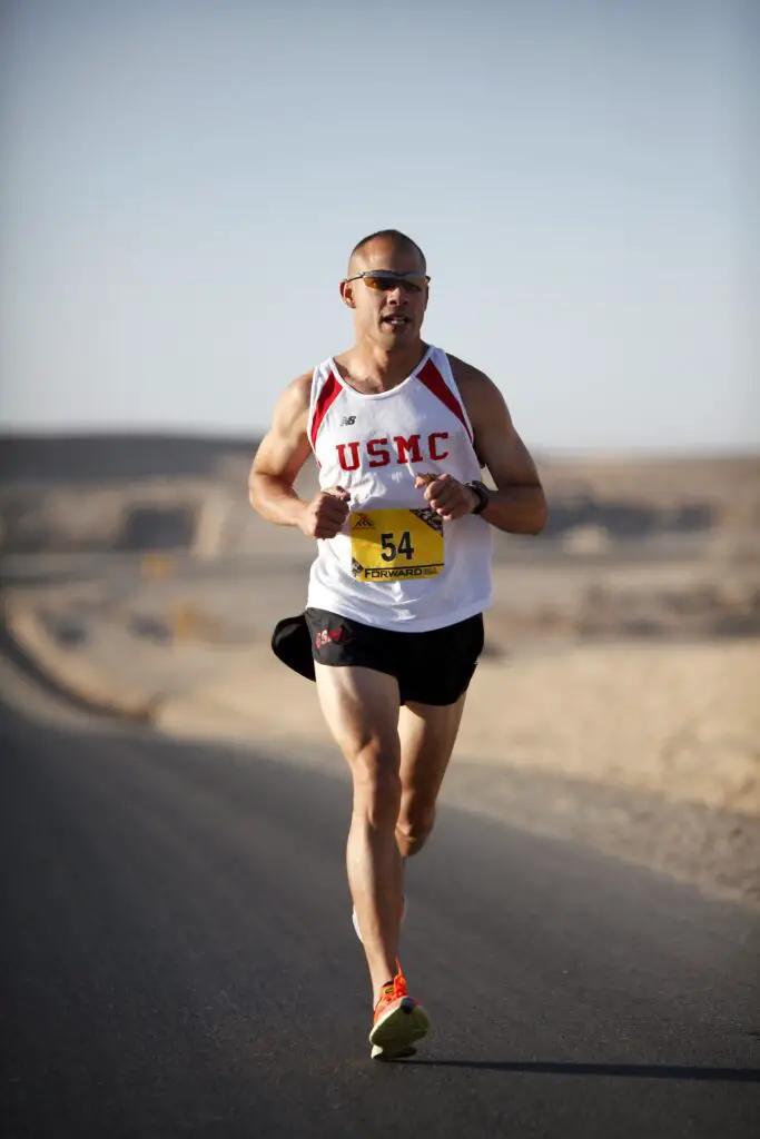 Man running on a road while wearing compression shorts