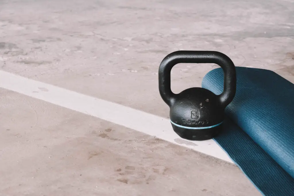 Kettlebell beside a mat placed on a floor