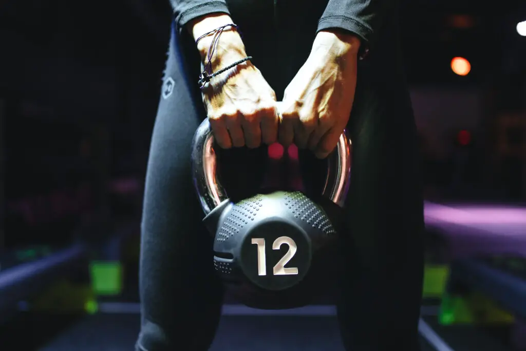 Person holding a kettlebell with both hands