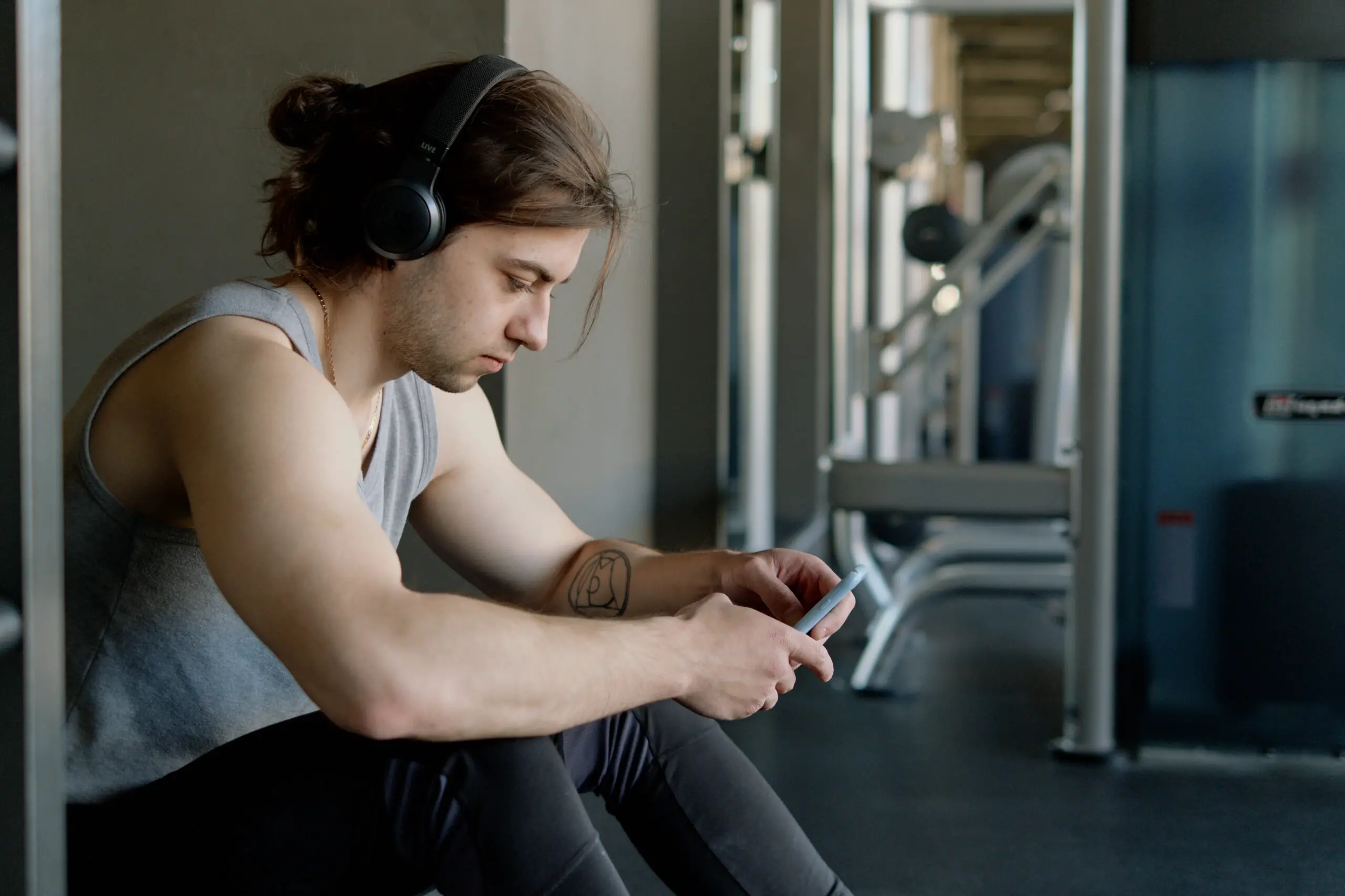 Man browsing through his iPhone for his kettlebell app