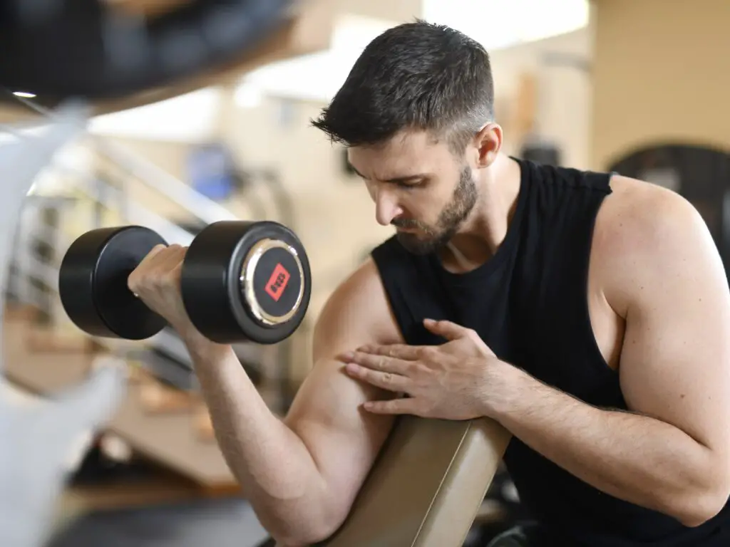 Man training to work on his biceps with dumbbells
