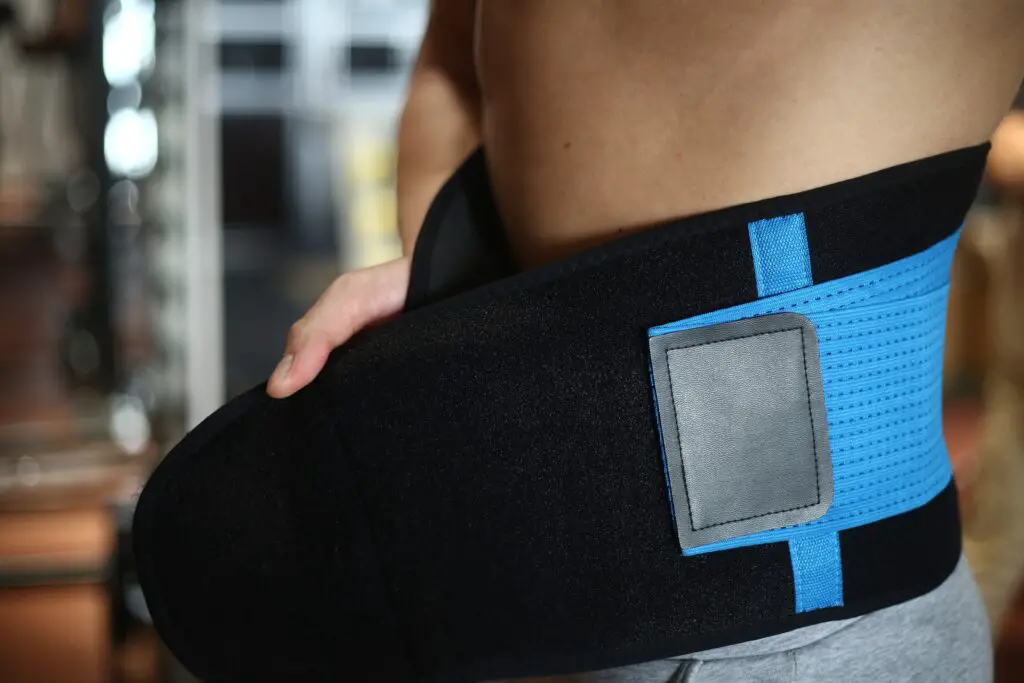 Man adjusting a waist trimmer