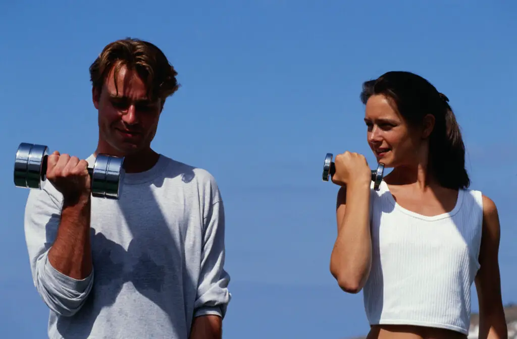 Woman wondering if the man's 30 lb dumbbells are heavy