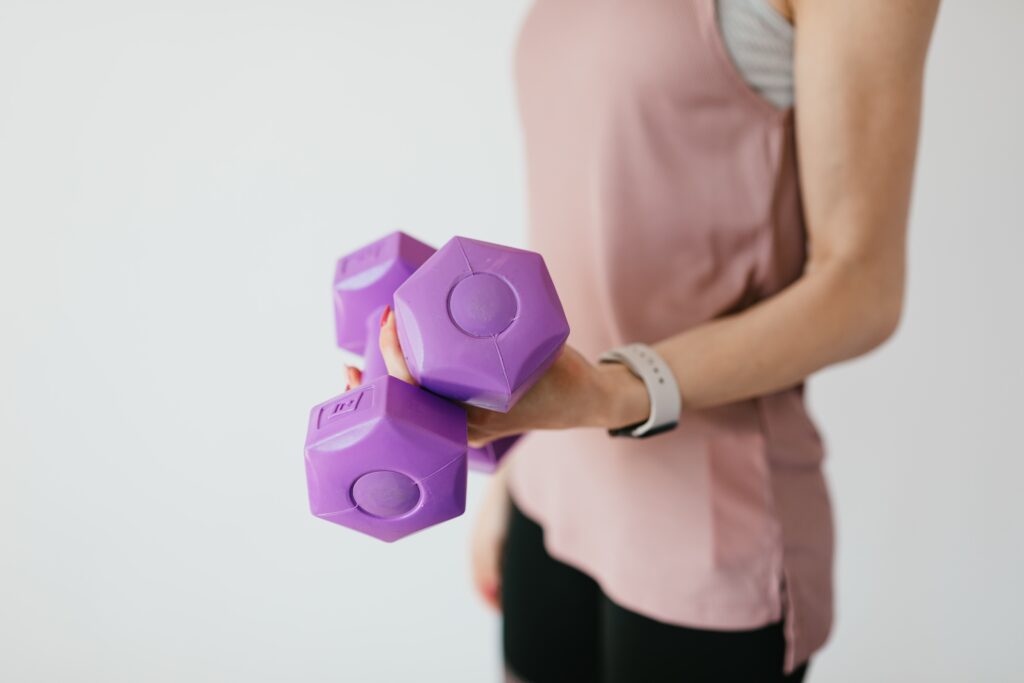 Woman wondering the best dumbbell weight for building muscle