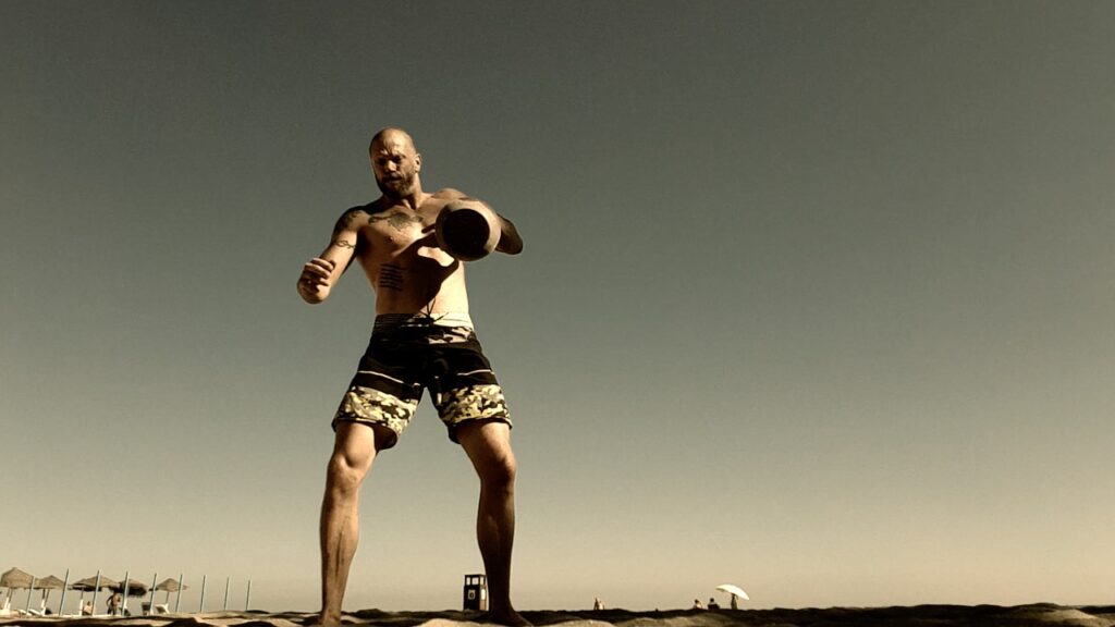 Man lifting a kettlebell with one hand