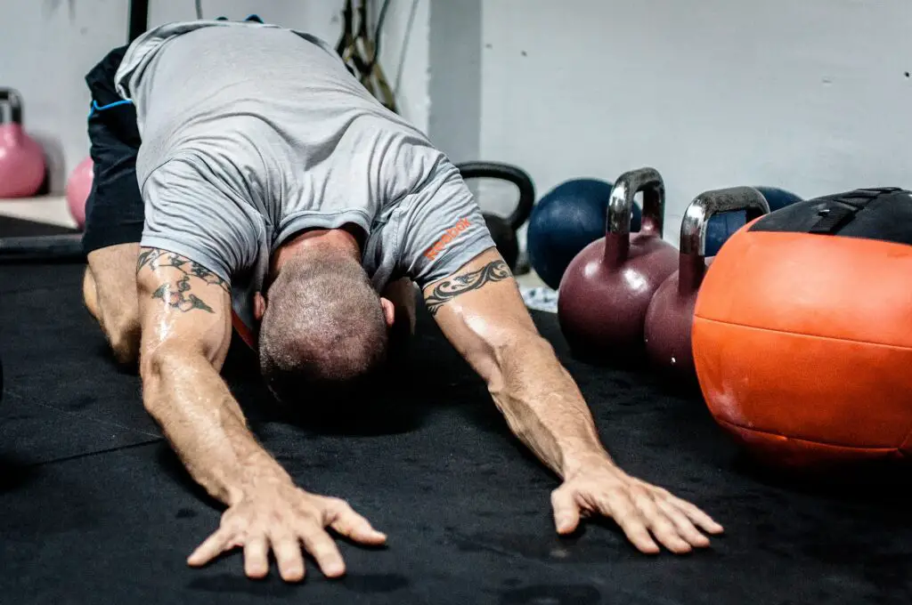 Man stretching before doing kettlebell workouts