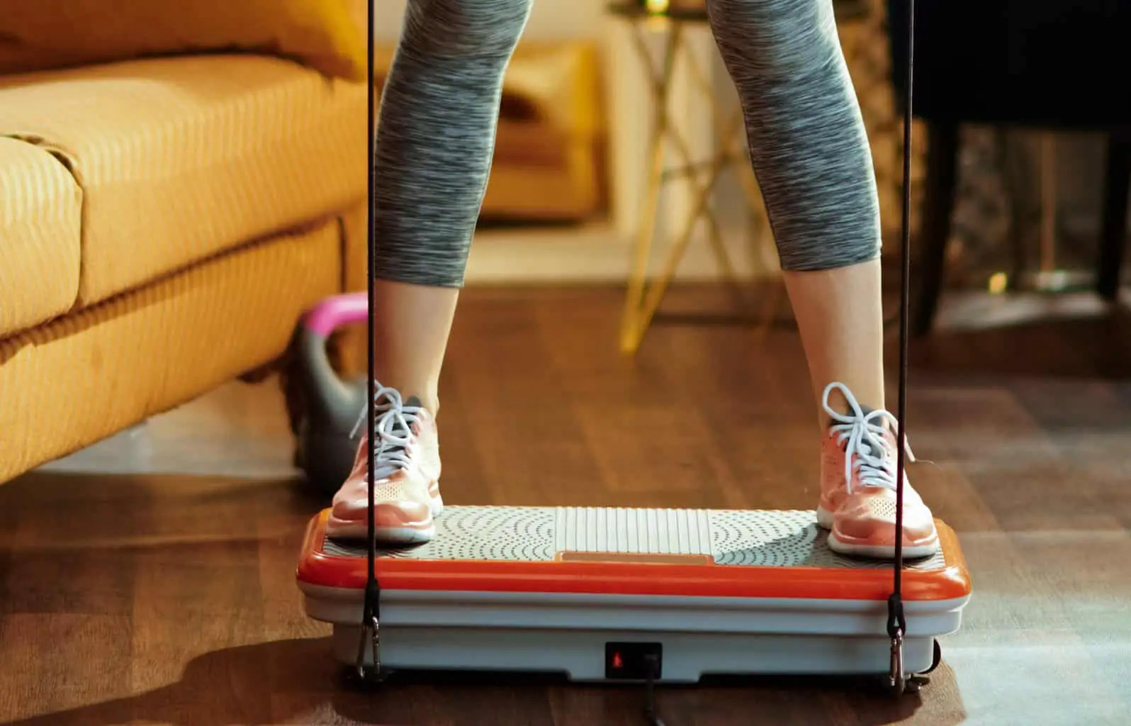 Close up of a person using a vibration machine at home