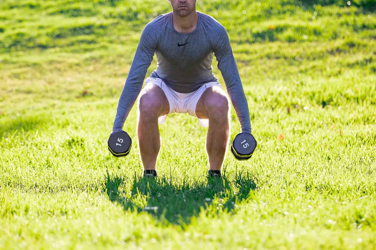 Man trying to lift dumbbells with each hands