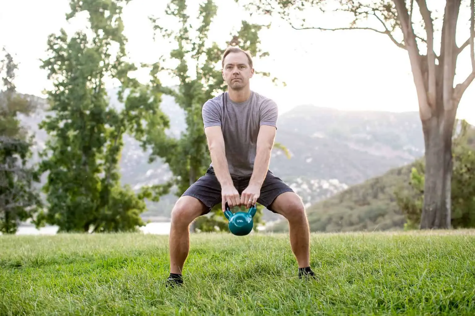 Man lifting a kettlebell with both hands