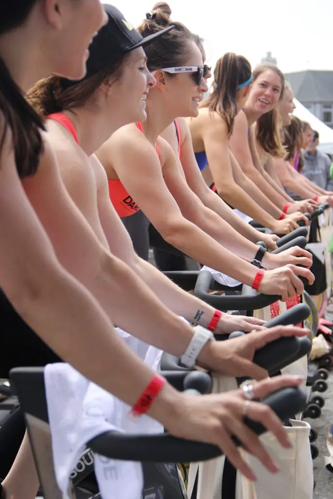 People in the gym using a spin bike