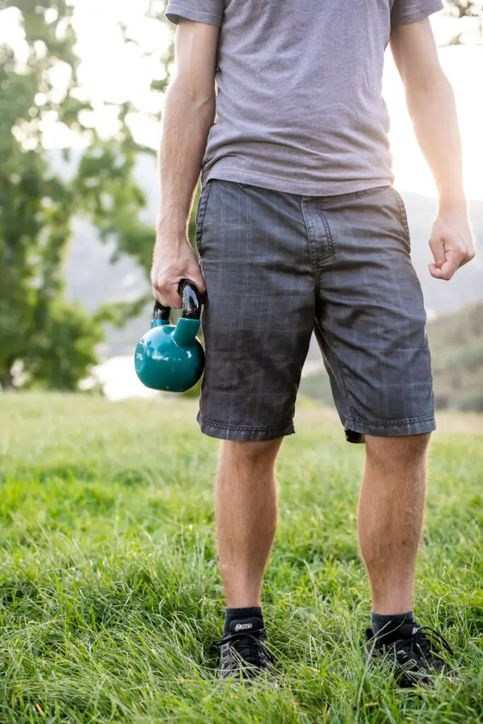Person holding a kettlebell with one hand