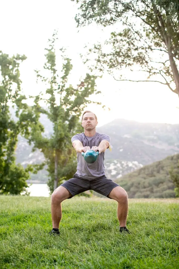 Man lifting a kettlebell with both hands