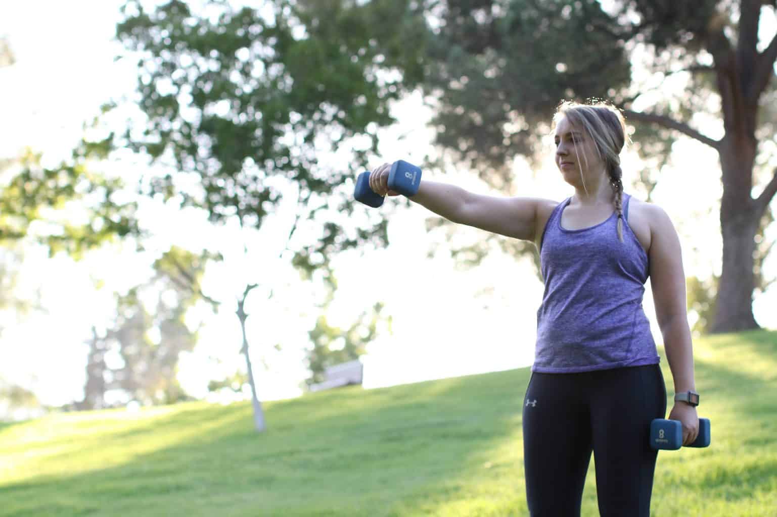 Woman lifting a dumbbell on her chest level