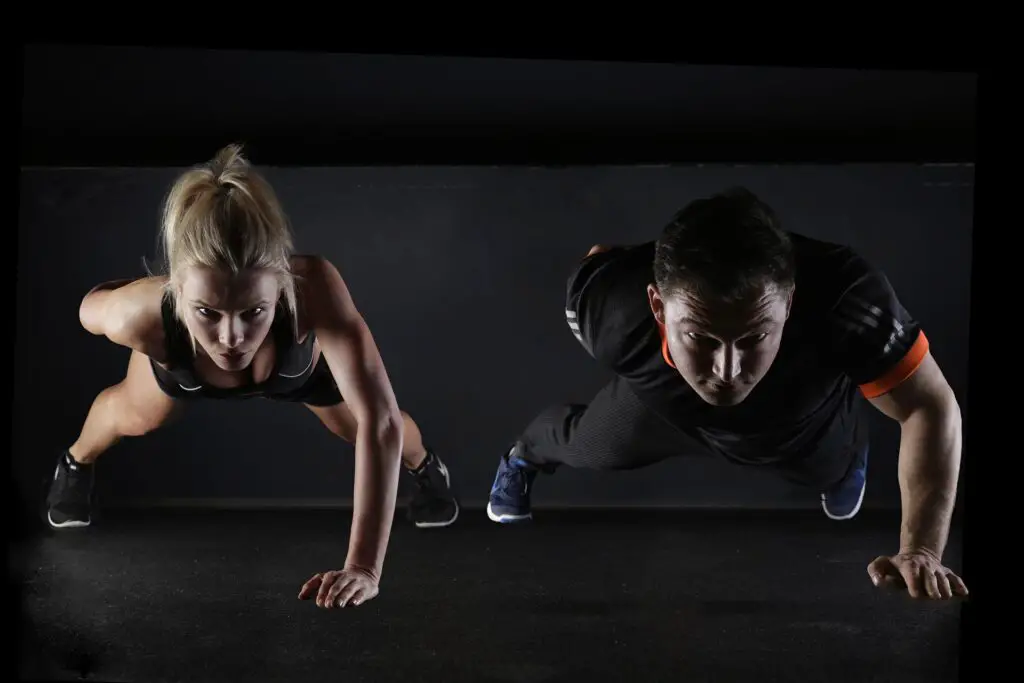 Couple doing non-weight exercises for their triceps, deltoids, pecs