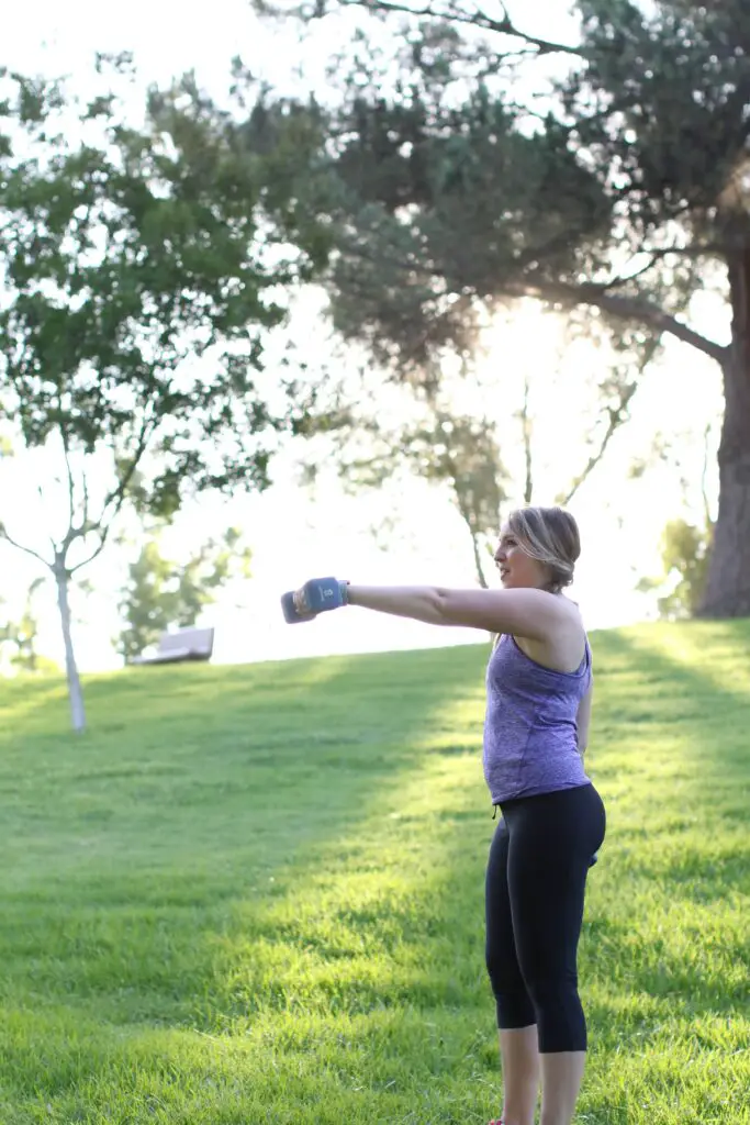Woman lifting a dumbbell on her chest level