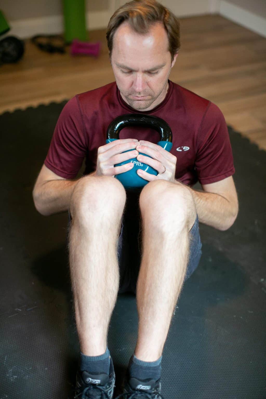 Man performing kettlebell crunches