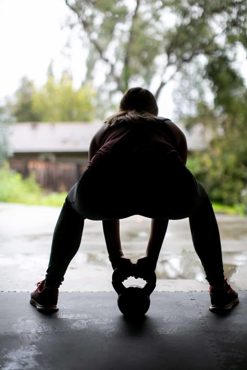 Woman working out using a kettlebell