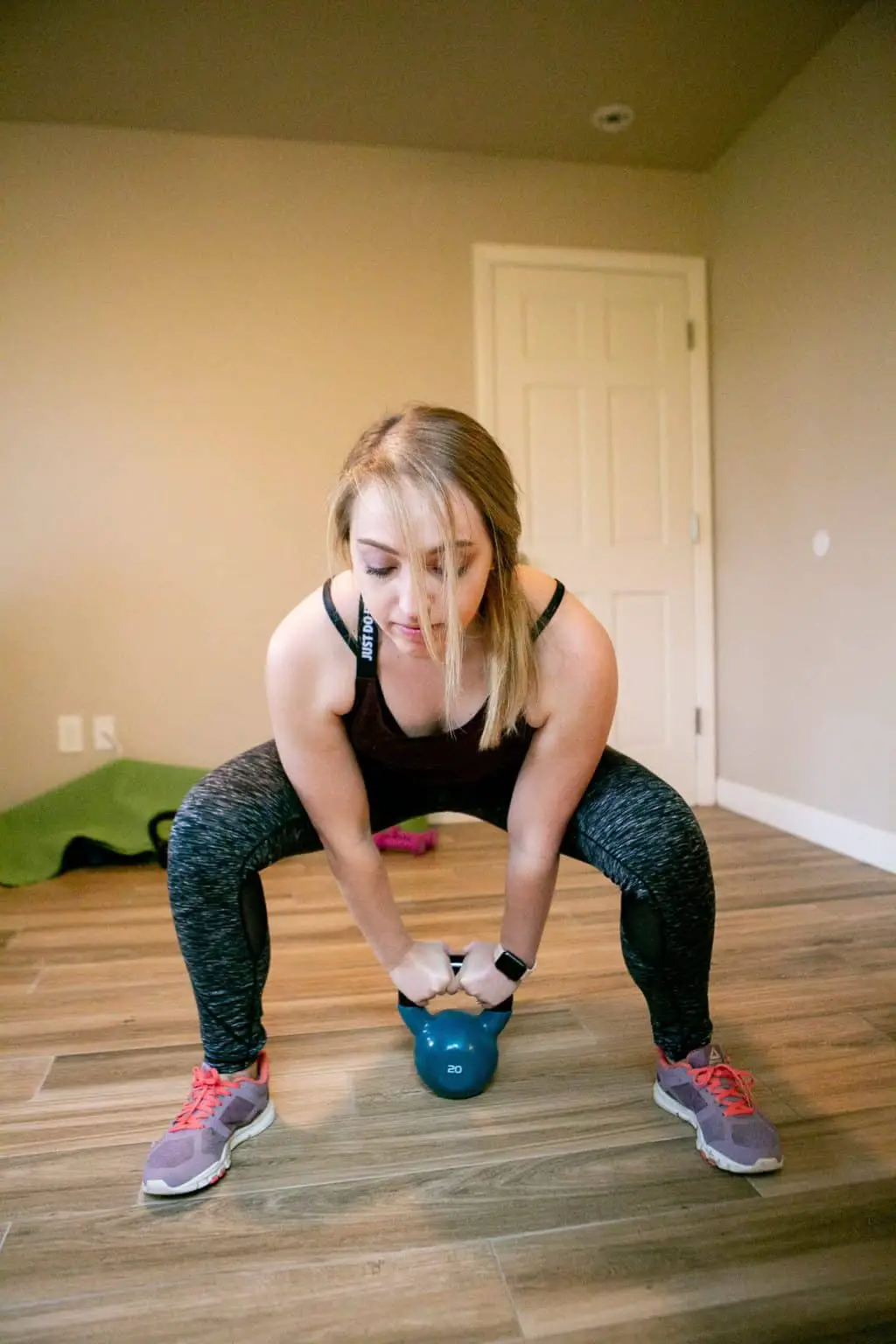 Woman gripping the kettlebell with both hands