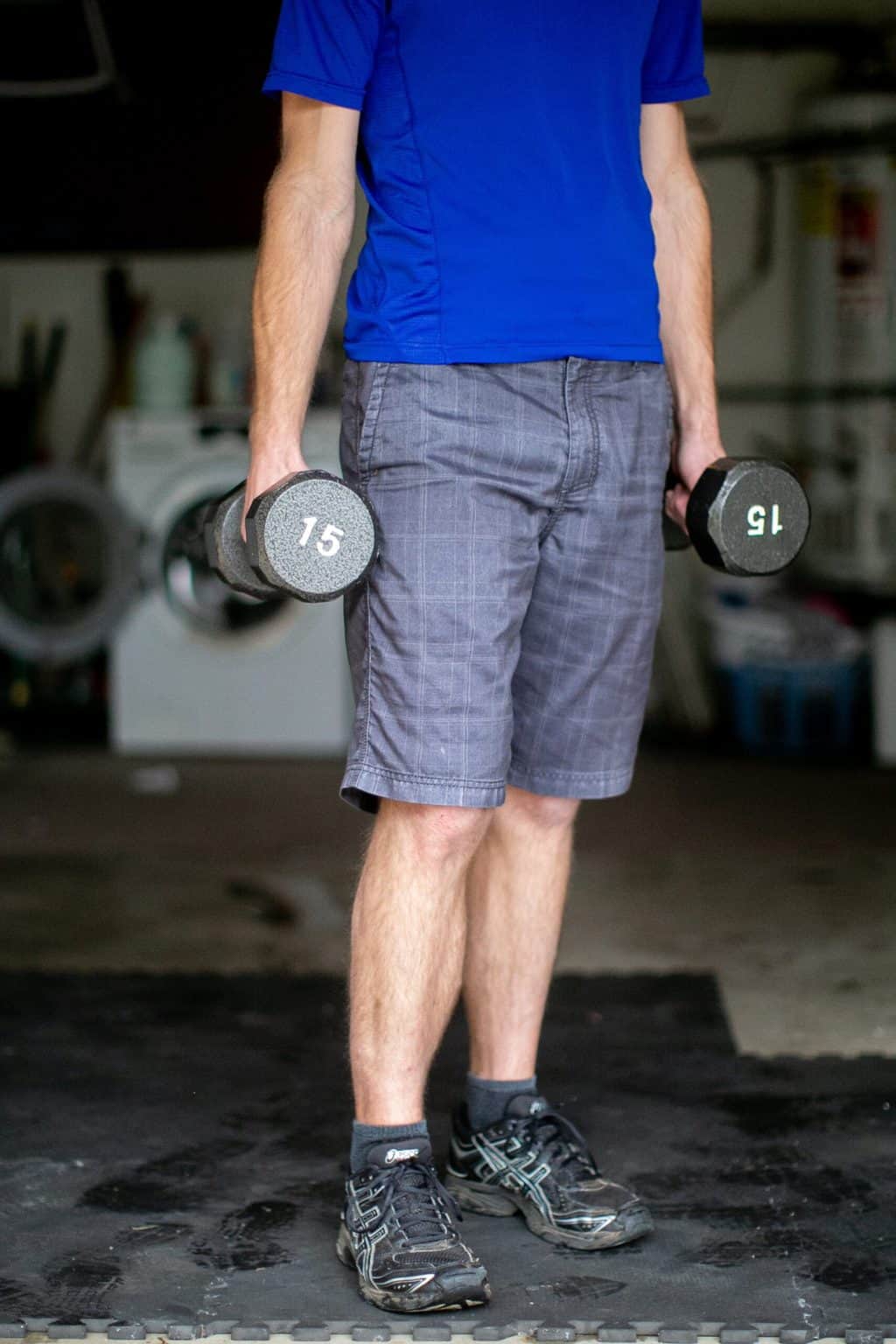 Man carrying 15lb dumbbell weights