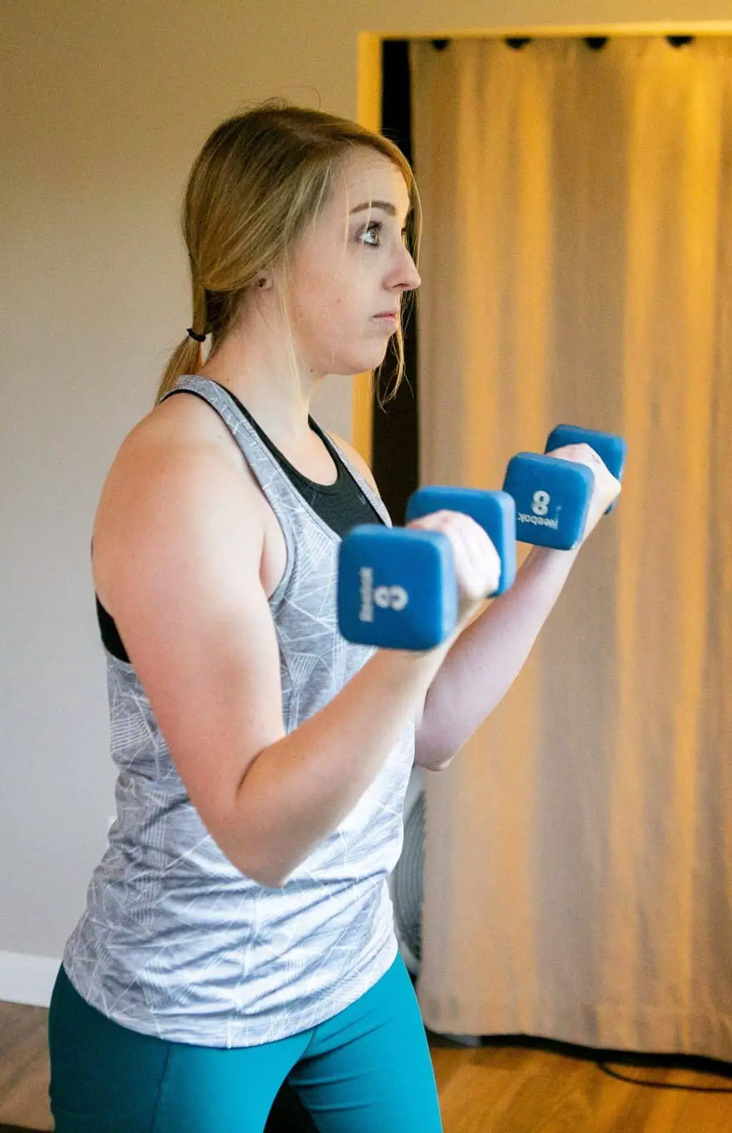 A woman doing dumbbell curls